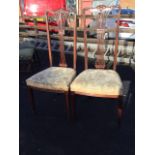 A pair of late nineteenth century mahogany chairs, the high backs carved with scrolled leaf