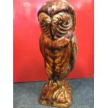 A large treacle glazed terracotta owl, the bird modelled on naturalistic square plinth. (21in)