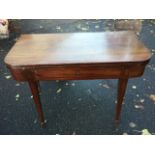 A nineteenth century mahogany turn-over-top tea table, with rounded twin leaves above an ebony