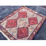 A South American rug woven with stylised birds & animals, having four red square lozenges with