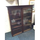 A Victorian glazed bookcase cabinet with moulded ogee cornice above glass doors enclosing adjustable