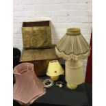 An embossed brass magazine rack; a scrolled brass tablelamp with pleated shade; two ceramic
