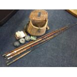 A cane fishing creel with canvas & leather mounts containing old tackle including a Cummins of