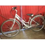 A Raleigh Oakland ladies bicycle with soft padded seat, water bottle holder, rear luggage rack,