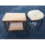 An oval scalloped top occasional table with conforming platform below, raised on cabriole legs;