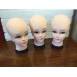A set of three female tailor dummy heads. (3)