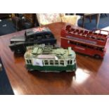 A tinplate model of a London taxi; another similar of a red double bus; and a European tram car. (