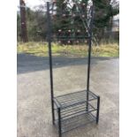A tubular metal hallstand, the back with two rows of pegs above a base with three rectangular rack