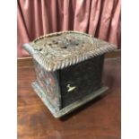 An eighteenth century carved oak box, the four sides decorated with chisel carved roundels, the