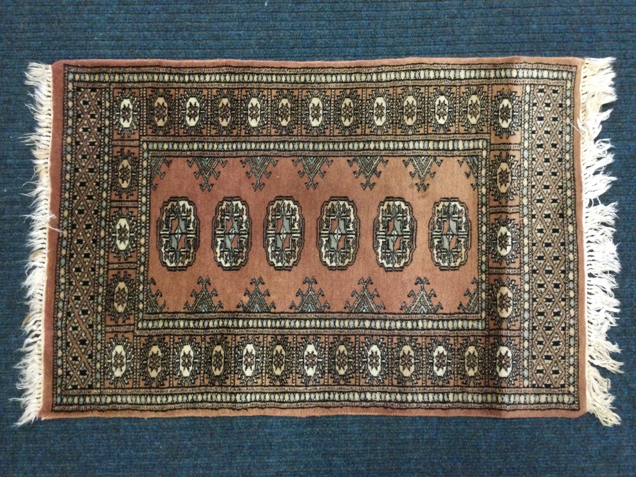 A Tekke style rug woven with six oval medallions on pink field framed by floral borders, the ends - Image 2 of 3