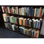 Three shelves of hardback books - reference, travel, contemporary novels, biographies, classics,