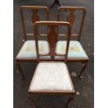 A set of three mahogany bedroom chairs with vase shaped splats above floral needlework drop-in