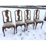 A set of four antique oak dining chairs, the Queen Anne style backs with scroll waved carved