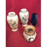 A pair of Japanese stoneware satsuma vases decorated with parrots and blossom foliage on crackle
