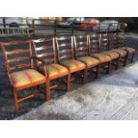 A set of eight mahogany ladderback dining chairs with two carvers, the back rails with pierced