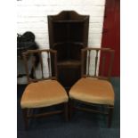 A pair of 18th century elm chairs with lathe backs above stuffover upholstered seats, raised on