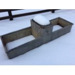 A 5ft rectangular riveted galvanised trough with tubular rim, the centre mounted with water
