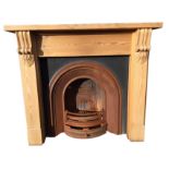 A pine & cast iron chimney piece, the thick mantleshelf on scroll carved corbels with plain jambs,