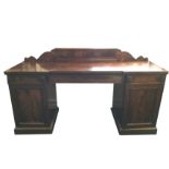 A Victorian mahogany pedestal sideboard with scroll decorated upstand, the right pedestal with