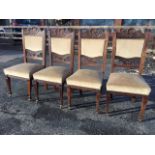 A set of four Victorian carved oak dining chairs, the backs with acanthus scroll carved rails