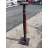 A Victorian mahogany jardinière stand with circular platform top on turned fluted column, with