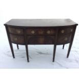 A bowfronted mahogany sideboard, the crossbanded top inlaid with ebony stringing, having