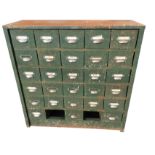 A metal cabinet containing 28 small drawers mounted with chromed label pulls. (36in x 12.25in x 36.