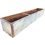 A long rectangular galvanised trough with tubular rim. (96in x 17.5in x 15.75in)