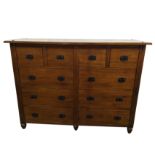 A contemporary stained chest of drawers with four short drawers above six long, mounted with iron