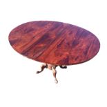 A Victorian rosewood drop-leaf supper table, the oval hinged top revolving on a baluster turned