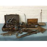 Miscellaneous tools including shears, clamps, planes, scales, a saw, a hammer, an oil can, pliers,