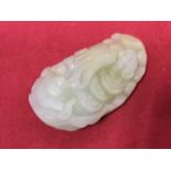 A carved jade pendant in the form of an octopus, the stone with shell type back, pierced for