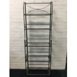 A set of 6ft metal framed shelves, the six rectangular hinged platforms folding on tubular frame -