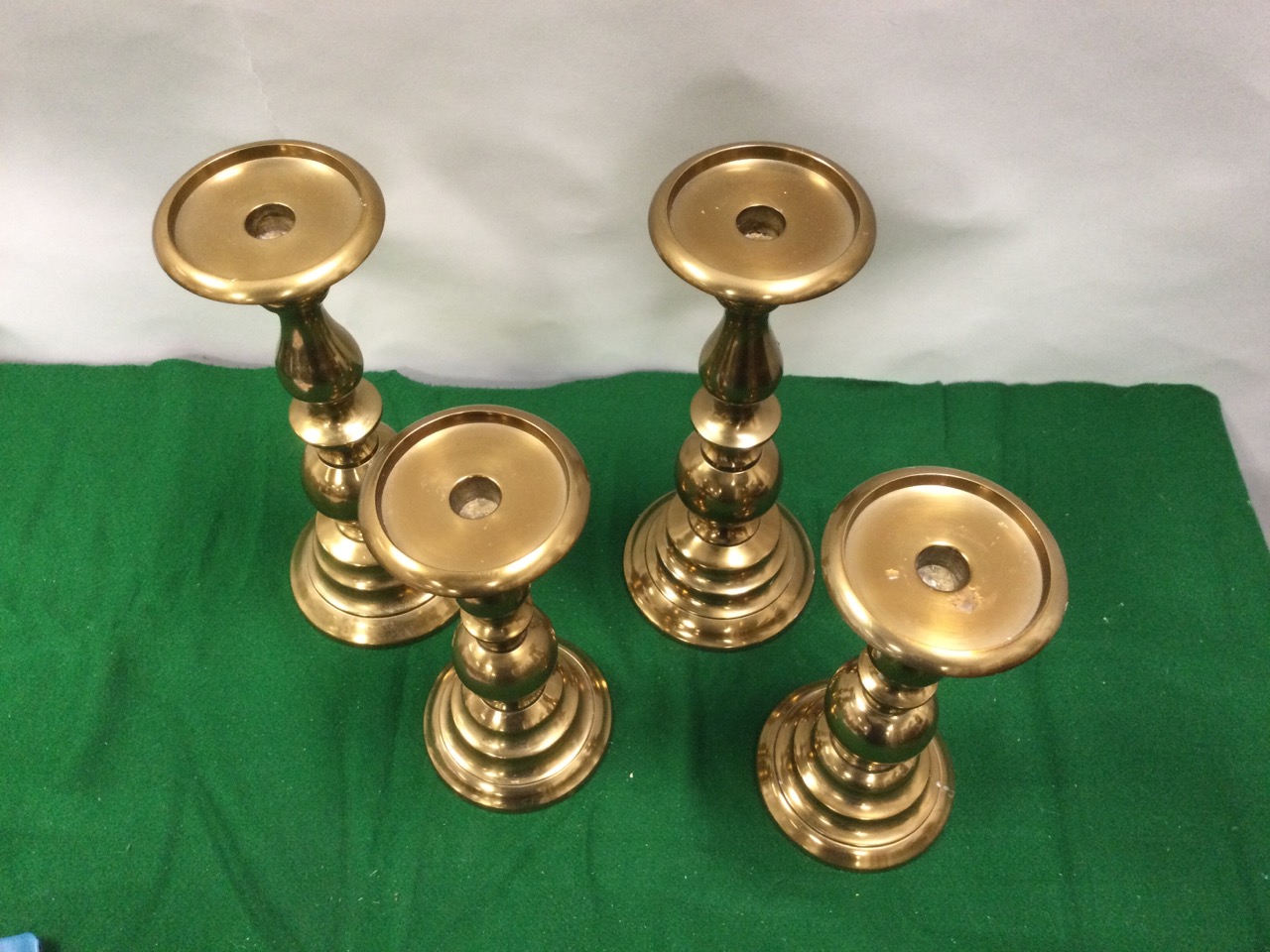 A pair of metallic copper candlestands with turned columns on circular moulded bases; and another - Image 2 of 3