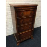 A reproduction yew column chest with slide above four graduated cockbeaded drawers, raised on