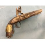 A flintlock pistol with ribbed barrel and brass mount to hardwood handle, the hammer with sprung