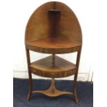 A nineteenth century mahogany bowfronted corner washstand, the later shaped top and back above an