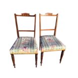 A pair of Edwardian mahogany bedroom chairs with rosewood inlaid panels to back rails, the stuffover