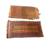 An antique belouch bag woven with rows of hooked motifs on red ground, the back kilim striped in red