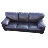 A three-seater 'Incanto' Italian leather sofa with stitched panels and cushioned arms, raised on