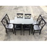 A modern ebonised dining table and chair set, the rectangular table on square tapering legs, the