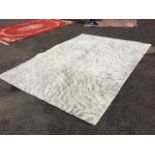 A modern tufted Amiga carpet woven with grey tendrils on ivory coloured ground. (137in x 97in)
