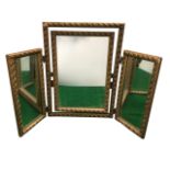 A gilt triptych dressing table mirror with leaf and bead moulding to frames, the central mirror with