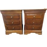 A pair of reproduction mahogany bedside chests, each with cushion moulded top drawers above three