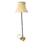 A tall gilt standard lamp having circular base on paw feet, with cream shade. (63in)