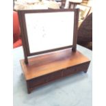 A nineteenth century mahogany dressing table mirror, the rectangular plate on ribbed angled supports