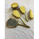 A five-piece guilloche enamelled ladies dressing table set with pair of hairbrushes, hand mirror,