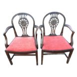 A pair of mahogany Hepplewhite style open armchairs, the arched backs with carved and pierced