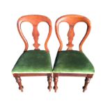 A pair of mahogany balloon back dining chairs with central vase shaped splats above stuffover