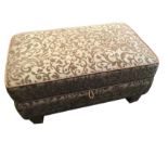 A contemporary upholstered ottoman, the rectangular stool with cushion hinged seat, revealing a box,